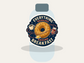 Round sticker with donut, coffee cup, and jam jars; text “EVERYTHING REVOLVES” and “AROUND BREAKFAST”.