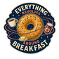 Round sticker with donut, coffee cup, and jam jars; reads “EVERYTHING REVOLVES” “AROUND BREAKFAST”.