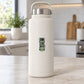 Green “Compile Test Snack” sticker on a white insulated bottle