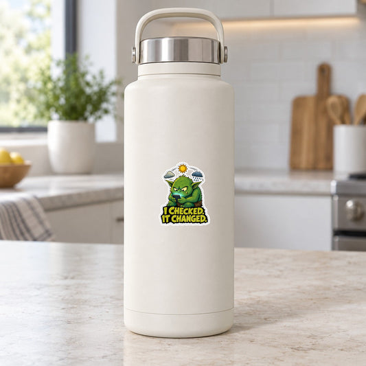 Forecast goblin sticker on a white bottle: green goblin with phone, “I CHECKED IT CHANGED.”