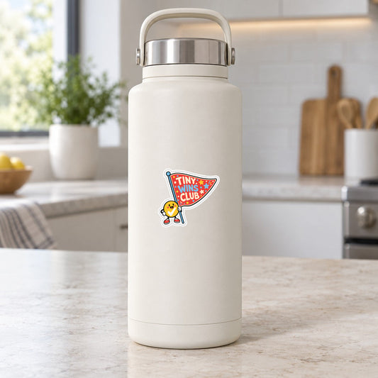 Tiny Wins Club sticker on a white insulated bottle