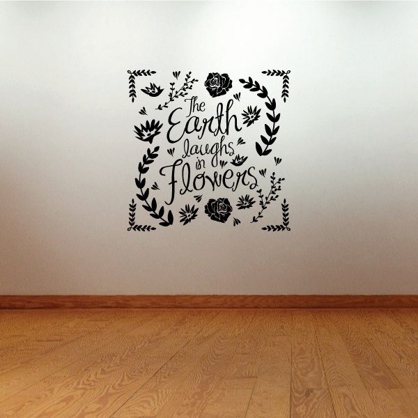 Floral wall decal with handwritten quote in black, surrounded by leaf wreath and flowers