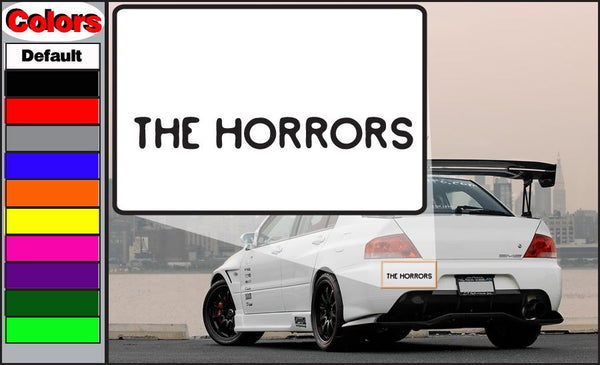 Car window decal with bold black text 'THE HORRORS' on white rectangle