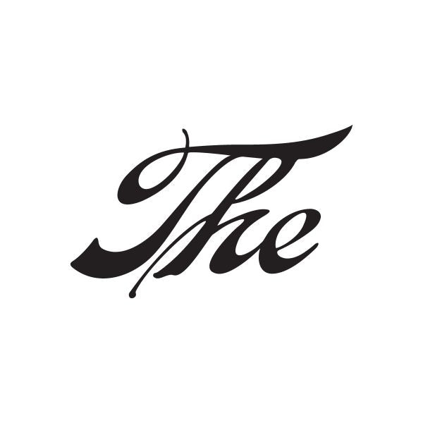 Vinyl sign decal with black cursive “The” lettering