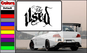 Used decal sticker with bold black stylized lettering on a white backing