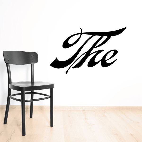 Vinyl wall decal with bold black cursive “The” lettering