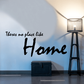 Home wall decal with 'There's no place like' cursive text