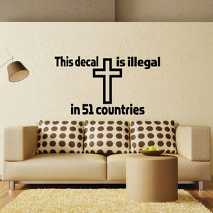Wall decal with black cross and message text: 'This decal is illegal in 51 countries'