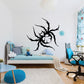 Spiky black spider wall decal with web-like legs and small blue accent