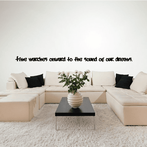 Wall quote mural decal with black handwritten-style text on a light wall.