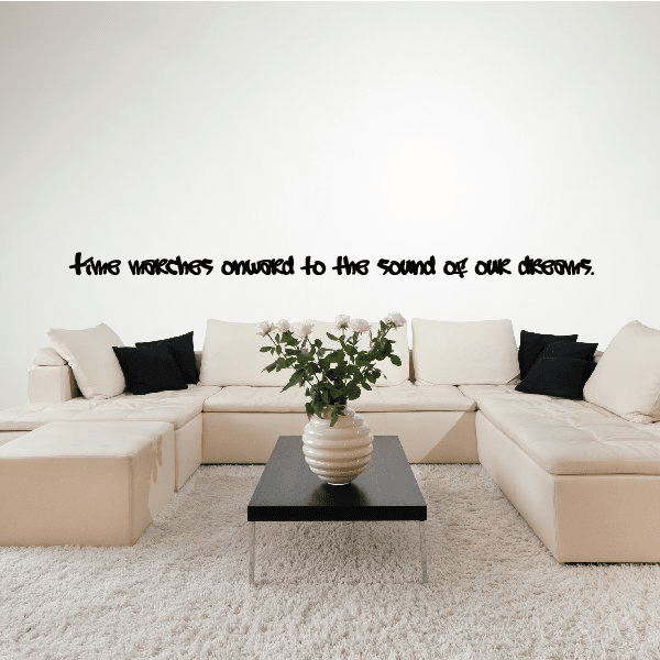 Wall quote mural decal with black handwritten-style text on a light wall.