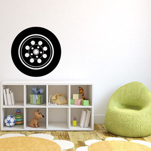 Vinyl tire rim wall decal with black circular wheel design and white accents