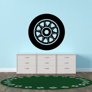 Black and white wheel rim wall decal with circular tire tread pattern