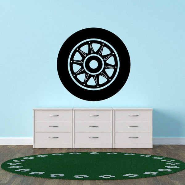 Black and white wheel rim wall decal with circular tire tread pattern