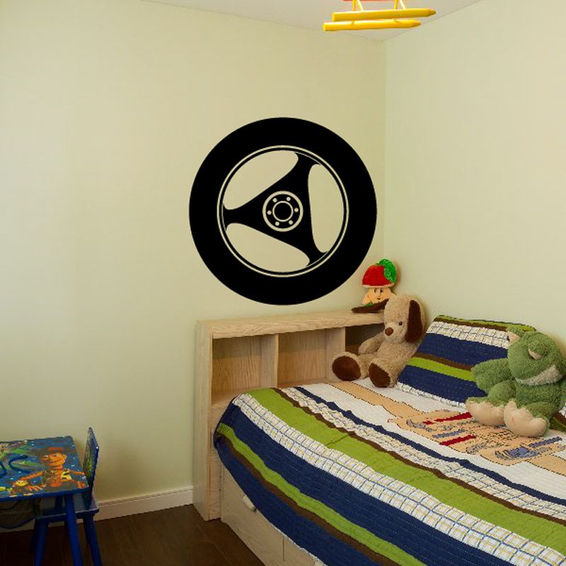 Black tire rim vinyl wall decal with steering hub icon, round design.