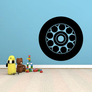 Vinyl tire rim wall decal: black circular rim with light blue tire tread design.