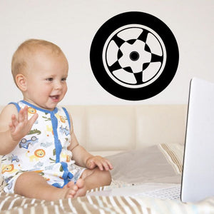 Circular tire rim wall decal with black outer ring and white checkered spokes