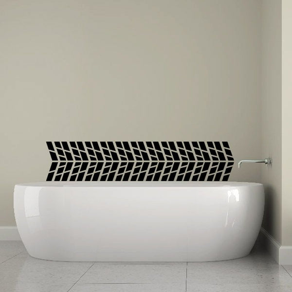 Black tire tread wall decal strip on wall above white bathtub