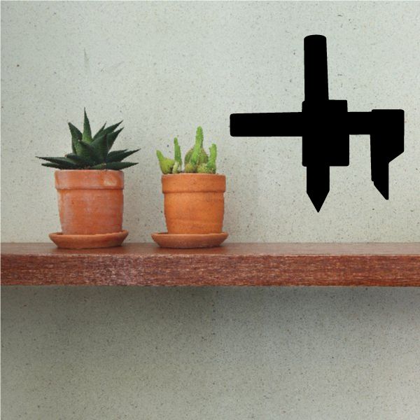 Black vinyl tool wall decal with cross-shaped symbol