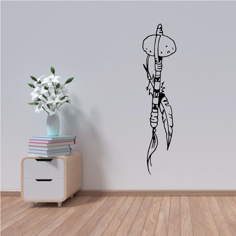 Tribal club decal with outlined humanoid figure holding a staff, black on light surface