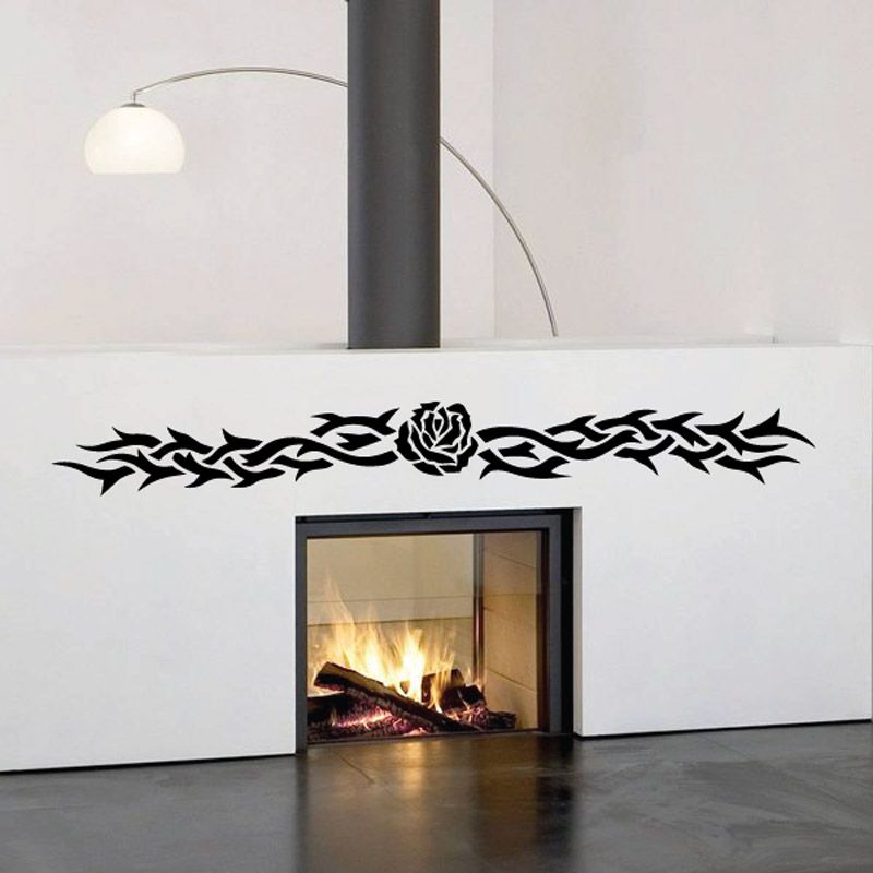 Black tribal rose wall decal with ornate banner across top of fireplace