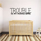 Wall decal with “TROUBLE IS MY MIDDLE NAME” in black all-caps letters.