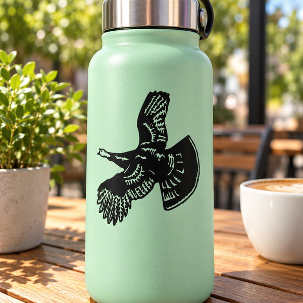 Black flying turkey silhouette decal sticker on a bottle