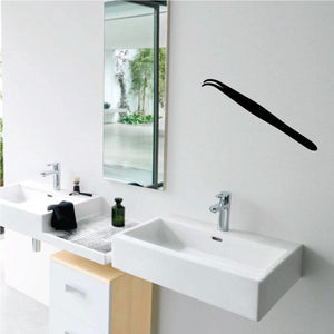 Tweezers decal: black tweezer-shaped wall graphic on a light background