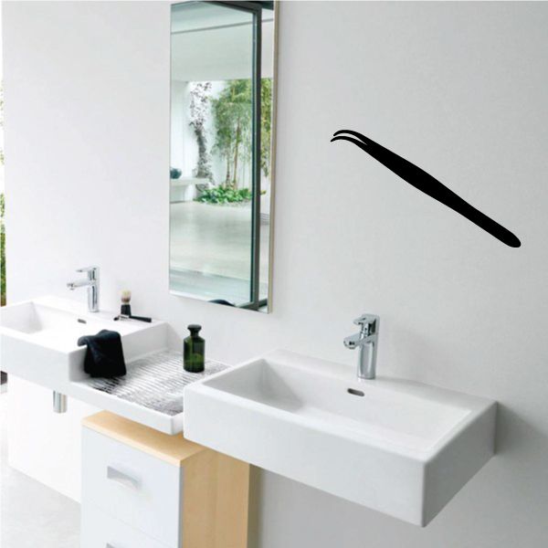 Tweezers decal: black tweezer-shaped wall graphic on a light background