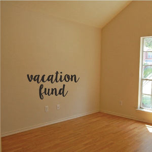 Wall decal with "vacation fund" text in black cursive lettering
