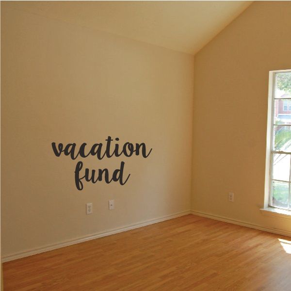 Wall decal with "vacation fund" text in black cursive lettering