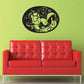 Oval black decal with light yellow animal silhouettes and decorative leaves