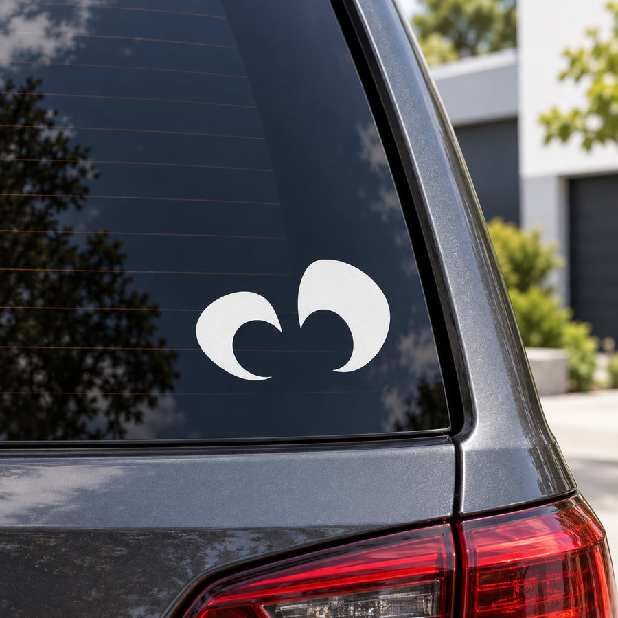 White surprised eyes decal on car rear window glass