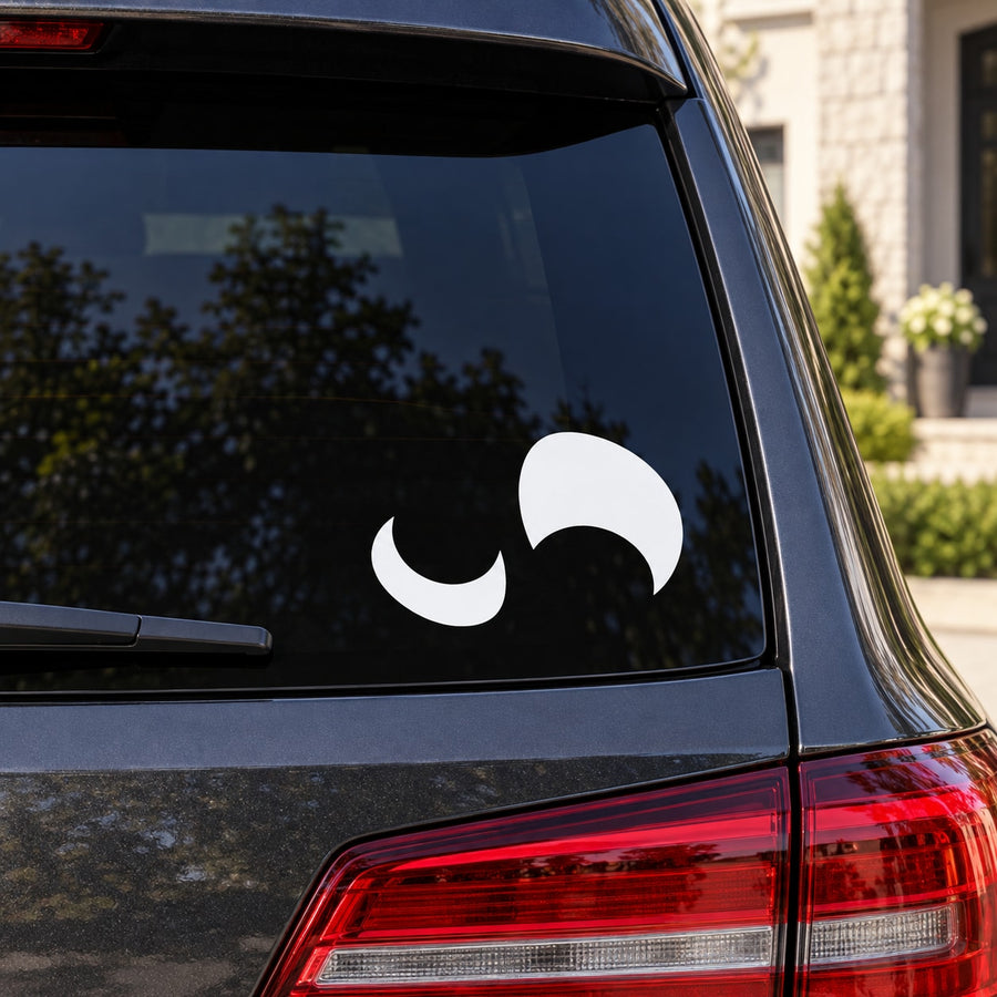 Halloween flipped-eyes face decal with white cartoon eyes on car window