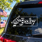 Car window wrapped text decal reading "the July" with fireworks and stars