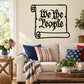 Scroll wall decal with 'We the People' text in black