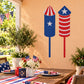 Stars and Stripes fireworks sticker with blue star rockets and red white stripes.