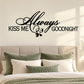 Black script wall decal: "Always Kiss Me Goodnight" with small floral accent