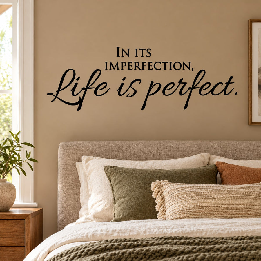 Wall decal with black cursive quote: 'In its imperfection, life is perfect'.