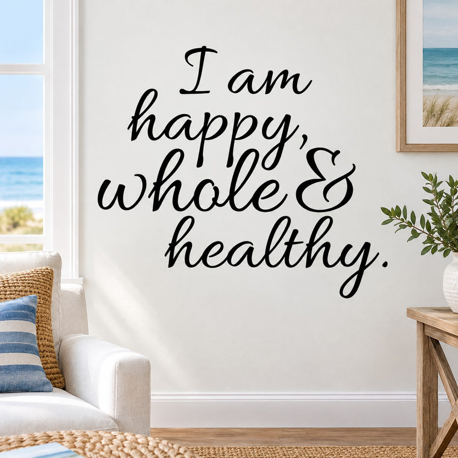 Wall decal with black cursive text: "I am happy, whole & healthy"