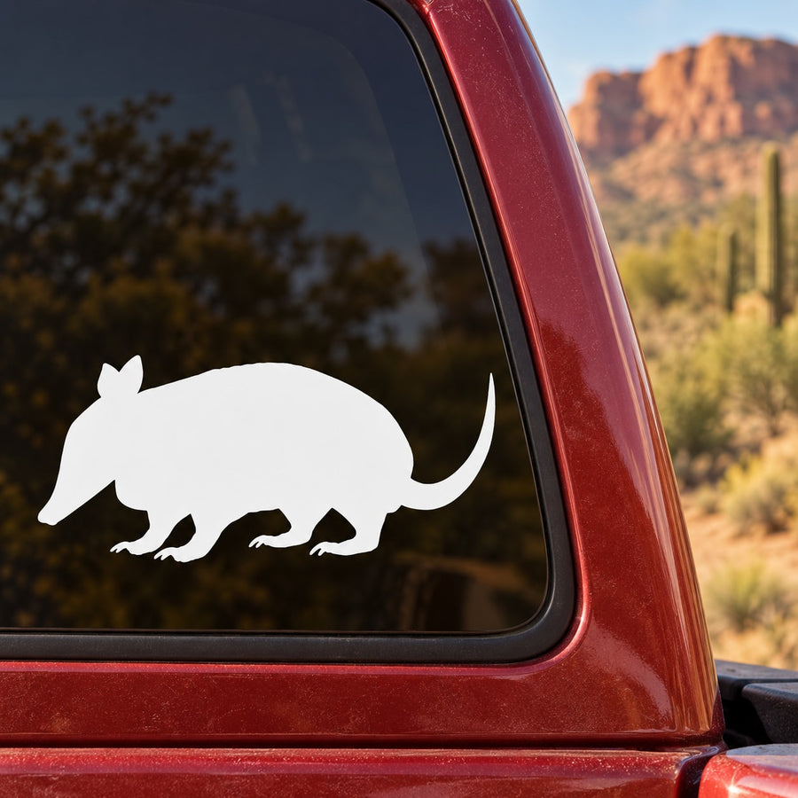 White armadillo silhouette decal on a car window