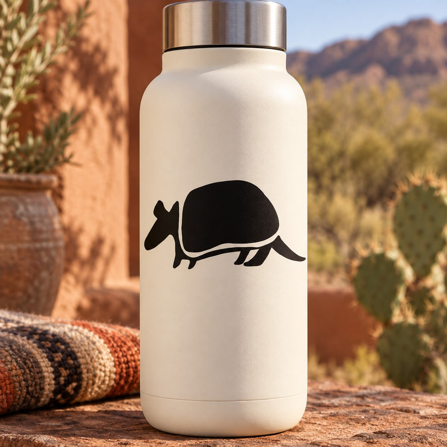 White bottle with black armadillo decal