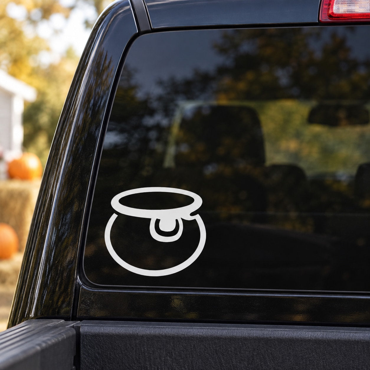 Halloween witch cauldron outline decal in white on a dark surface