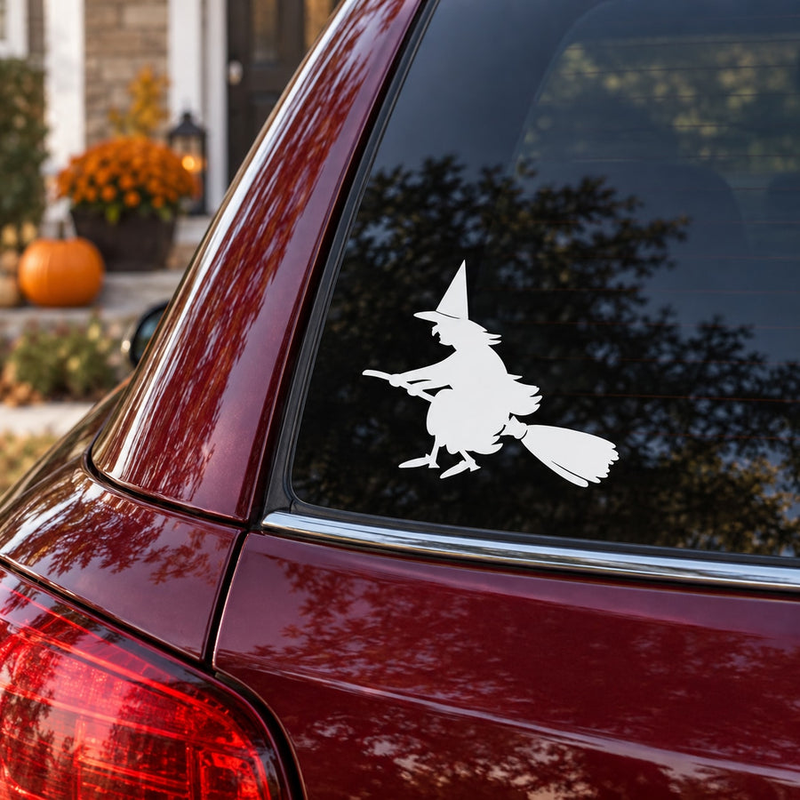 White Halloween witch on broom decal on maroon car window
