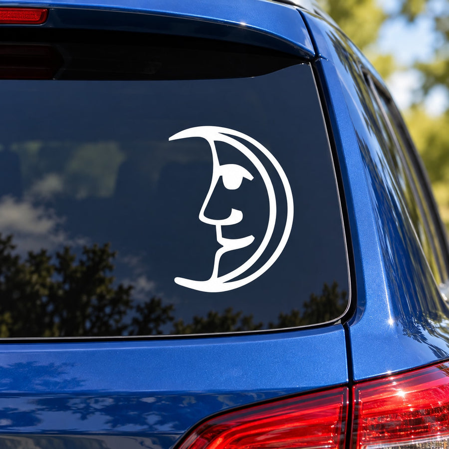 Happy crescent moon decal: white face in crescent outline on car window.