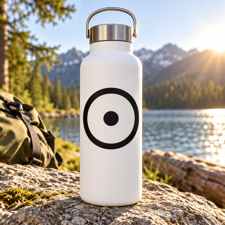 Astrological sun decal with black circular sun symbol on a white water bottle