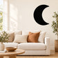 Waxing gibbous moon wall decal, black crescent on plain wall above sofa