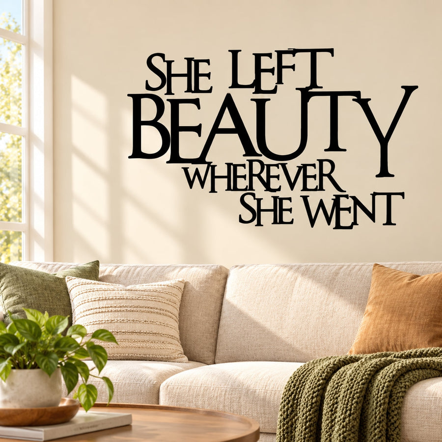 Inspirational wall decal with bold black text: She left beauty wherever she went
