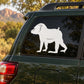 White baboon silhouette decal on a dark car rear window