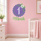 Purple floral '1 Month' wall decal with green vines and white flower accents